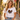 Frau traegt weisses JGA T-Shirt mit Retro-Regenbogen-Schriftzug Braut Crew in sommerlicher Altstadtgasse
