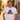 Mann traegt weisses JGA T-Shirt mit Retro-Regenbogen-Spruch Heute bunt Morgen verheiratet in sommerlicher Altstadtgasse