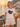 Freundin der Braut traegt weisses JGA T-Shirt Braut Crew Retro Regenbogen auf Positano-Balkon