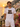 Mann traegt weisses JGA T-Shirt Verliebt Verlobt Verbunt Retro Regenbogen auf Positano-Balkon