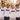 JGA Crew mit Braeutigam im Retro-Regenbogen-Shirt in der Altstadt bei goldener Stunde