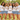 JGA-Lifestyle: Braut im Braut-Gold-Shirt mit Freundinnen in Team-Braut-Shirts auf sommerlicher Wiese