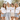 JGA-Gruppe auf sonniger Terrasse: Braut im Bride-Shirt mit Eukalyptuszweigen, Freundinnen im Bride-Squad-Shirt