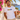 Mann trägt weißes JGA T-Shirt mit LGBIERTQ+ Retro-Pride-Print auf Mallorca-Terrasse